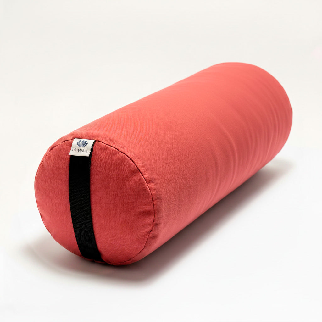 Papaya Round Yoga Bolster with black carrying strap on a white background