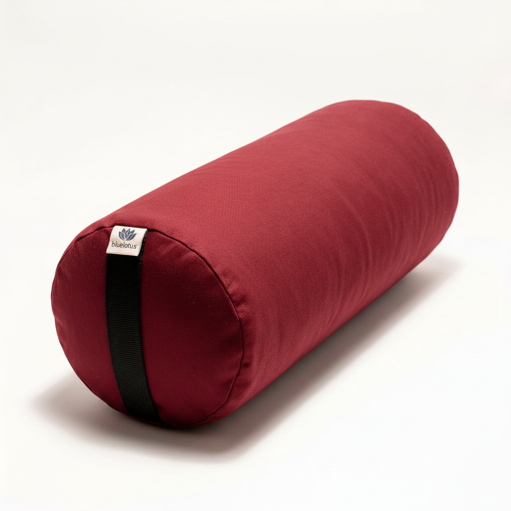 Red Round Yoga Bolster with black carrying strap on a white background
